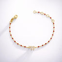 Bracelet fin en argent plaqué or jaune Eliorness avec petites perles rouges et pendentif symbole Haï serti de zirconium brillants – Style fin et moderne.