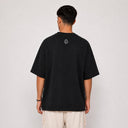 Vue arrière du t-shirt Tsitsit noir effet lin Eliorness montrant la mini flamme Aech Sheli brodée discrètement en haut du dos.