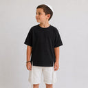 T-shirt Tsitsit enfant noir effet lin, coupe oversize ample de la marque Eliorness avec fentes latérales et zips métalliques.